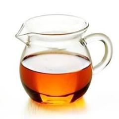 Glass tea pitcher with amber tea licqueur