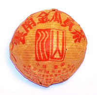 Golden Melon Chinese Shou Pu-erh tea tuo wrapped in gold packaging with red writing