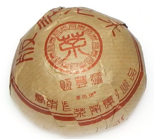 Bana Tuo Shou Pu-erh tea tuo in brown packaging with red characters