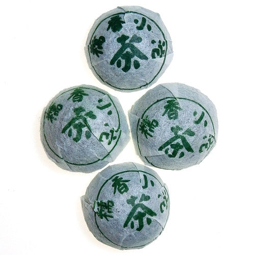 4 Sweet Rice Mini Sheng Pu-erh tea Tuo wrapped in white packaging with green characters