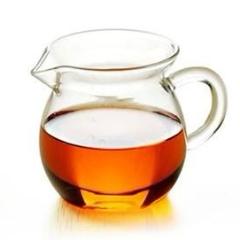 Glass tea pitcher with amber tea licqueur 
