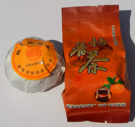 Jipu Cha Mandarin Chinese Shou Pu-erh tea tuo wrapped in white packaging with an orange sticker and an orange outer packaging